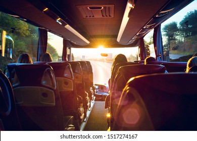 View from inside a stage coach Bus into the sunset - Bus interior trip with a bokeh back light front screen