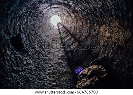 View from inside vertical tube downcast shaft with ladder 