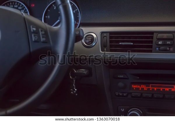 View of the interior of a modern car, steering\
wheel and radio panel