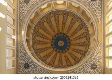 A view of the interior of a mosque showcasing a stunning ornate dome, adorned with intricate patterns and details. The dome is a symbol of Islamic architecture, representing the sky and the divine. - Powered by Shutterstock