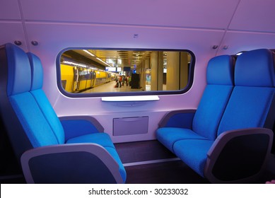 View Of Interior Of A Train,blue Seats. Through The Window The Underground Station