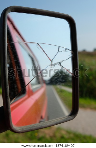 view into the\
broken rear view mirror of a\
car