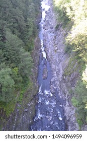 View into deep gorge with small river flowing