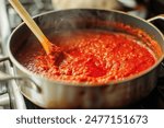 View into a pot while cooking a red sauce