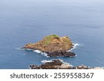 View of the island ‘Snail Rock’ on the coast of Porto Moniz on the island of Madiera (Portugal)