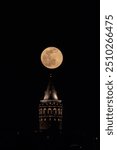 View of Istanbul Galata Tower with full moon from Eminonu. Turkey
