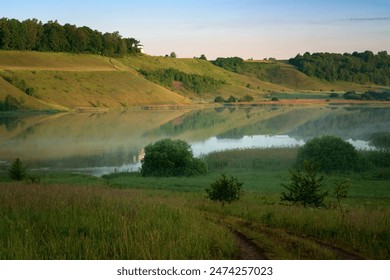 View of the Izborsko-Malskaya Valley and Gorodishchenskoe Lake on a sunny summer day, Izborsk, Pechersk district, Pskov region, Russia - Powered by Shutterstock