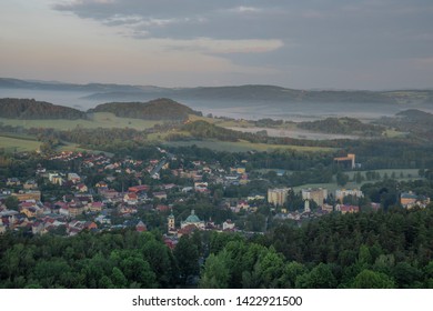 View from Jehla hill over Ceska Kamenice town in spring misty morning in national park - Shutterstock ID 1422921500