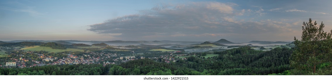 View from Jehla hill over Ceska Kamenice town in spring misty morning in national park - Shutterstock ID 1422921515