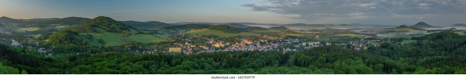 View from Jehla hill over Ceska Kamenice town in spring misty morning in national park - Shutterstock ID 1427559779