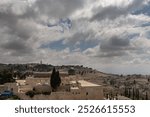 View of Jerusalem and the Al-Aqsa Mosque with its black dome on the Temple Mount compound and the Mount of Olives and Mount Scopus in the distance. 