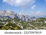 A view of the Julian Alps in Triglav national park. Mountain peaks are partially covered in permanent snow. Beautiful texture of typical limestone rock.