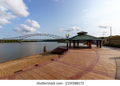 A View Of Julien Dubuque Bridge And A Gazebo By Mississippi River Against A Blue Sky On A Sunny Day