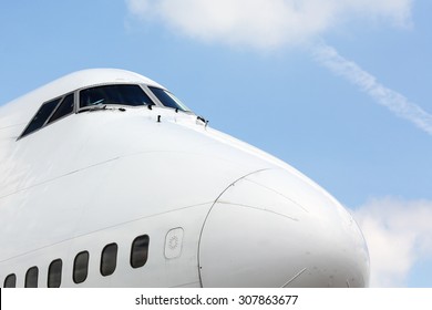 View of jumbo-jet airliner front and nose in generic, white paint scheme