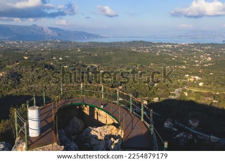 View of Kaiser's Throne observation deck lookout, Pelekas village, Corfu island, Greece, Kaiser William II summit Observatory panoramic summer view with mountains, sea and Kerkyra in the background