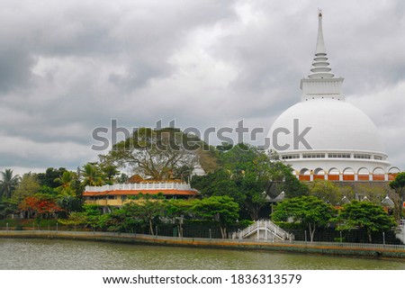 View of Kalutara temple (stupa and sacred bodhi tree) on Kalu Ganga river bank. Kalutara, Sri Lanka.