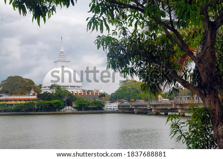 View of Kalutara temple (stupa and sacred bodhi tree) on Kalu Ganga river bank. Kalutara, Sri Lanka.