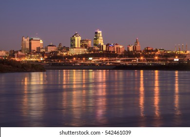 A view of the Kansas City skyline at twilight with reflections in the Missouri River