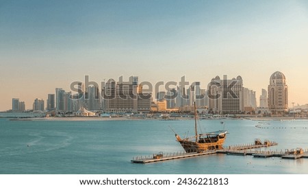 View from Katara Beach timelapse during sunset in Doha, Qatar, towards the West Bay and city center. Old ship on foreground