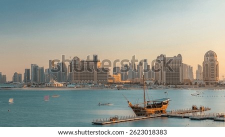 View from Katara Beach timelapse during sunset in Doha, Qatar, towards the West Bay and city center. Old ship on foreground