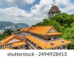 View of the Kek Lok Si Temple in Air Itam, Penang, Malaysia. The largest Buddhist temple in Malaysia is a popular attraction among tourists and pilgrims of Asia. George Town is visible in background.