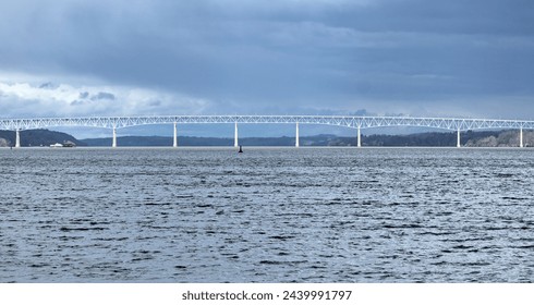 view of the Kingston-Rhinecliff Bridge from Kingston point beach (continuous under deck truss toll bridge across hudson river in new york state)