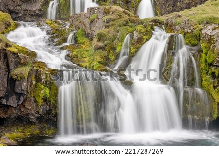 View at Kirkjufellsfoss cascade waterfalls, famous and popular tourist spot in Iceland