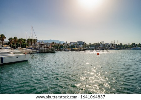 View of Kos harbor quay with ships on sunny day. Greece