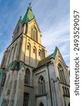 View of Kristiansand Cathedral, Norway. The gray, brick church was built in a Neo-Gothic cruciform design in 1885