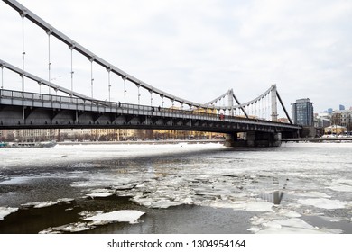 view of Krymsky (Crimean) Bridge over Moskva River with floating ice blocks in Moscow city in winter day. Krymsky Bridge is the only suspension bridge in all of Moscow