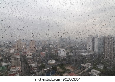 view of kuala lumpur city from building window when it rains.
there are raindrops on the window.
 - Powered by Shutterstock