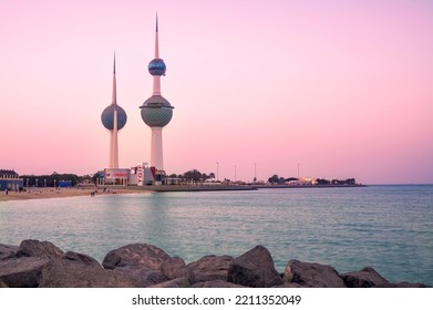 View of the Kuwait skyline - with the best known landmark of Kuwait City - during sunset. Kuwait City skyline with sky colours and beach visible.
