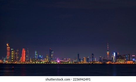 View of the Kuwait skyline - with the best known landmark of Kuwait City - during Night. Kuwait City buildings and skyline from beach at night

