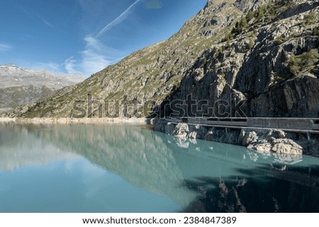 View of the Lac d'Emosson and concrete walkways on mountain side over the Emosson hydroelectric dam in the Alps in Switzerland