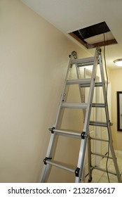 View of a ladder to access the scuttle attic. - Shutterstock ID 2132876617