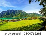 View of Lake Achensee in Tyrol. Nature at the turquoise lake and a mountain landscape in the background. Achental in Austria.	