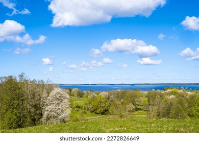 View at a lake in a rural landscape with budding trees - Shutterstock ID 2272826649
