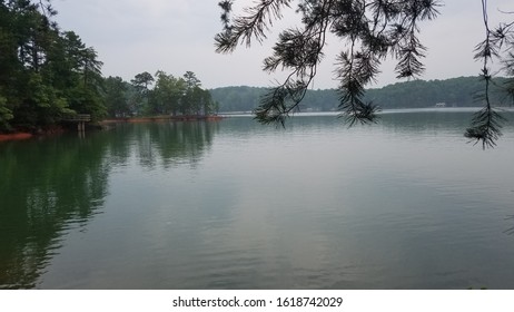 A view of the lake while it is overcast with a selection of the sky and docks in the distance.