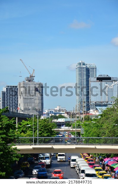 View landscape cityscape with asian labor people\
and thai labour workers use heavy machinery working builder new\
build concrete structure at construction site on June 18, 2022 in\
Bangkok, Thailand