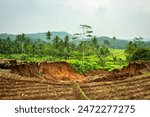 View of a Landscape shot of dangerous landslide occurred due to heavy rainfall, landslide natural disasters in hilly areas, Massive landslide.