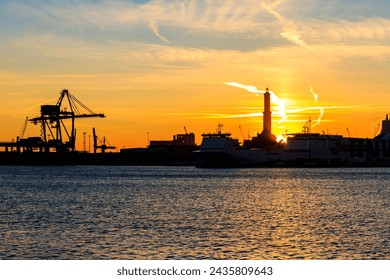 View of Lanterna (lighthouse) in the old port of the city of Genoa at sunset, Italy