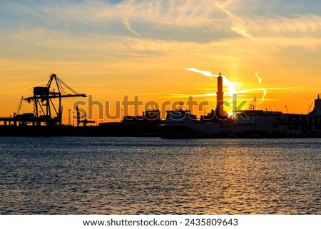View of Lanterna (lighthouse) in the old port of the city of Genoa at sunset, Italy