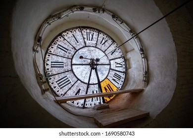 View of the large clock-face of an antique clock on the tower.