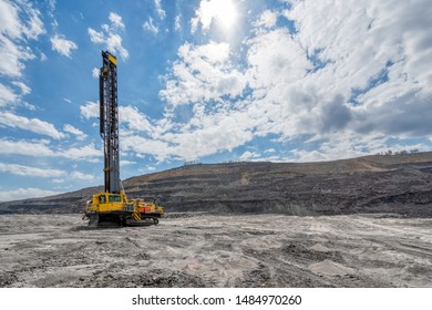 View Of A Large Quarry For The Extraction Of Limestone And Coal. The Drilling Machine Makes Wells For Blasting.