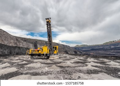 View Of A Large Quarry For The Extraction Of Limestone And Coal. The Drilling Machine Makes Wells For Blasting.