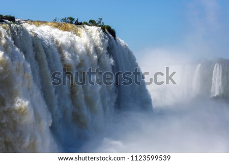 View of large waterfall in Foz do Iguaçu, Brazil, creating mist with other waterfalls in the background