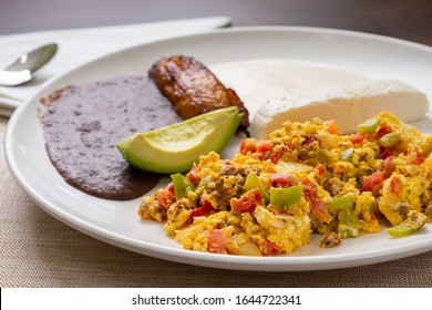 A View Of A Latin American Breakfast Plate In A Restaurant Or Kitchen Setting.