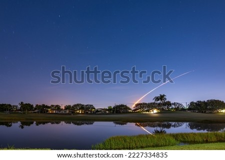 View of the launch trajectory of the Artemis 1 rocket with reflection in the lake at Boynton Beach, Florida, USA