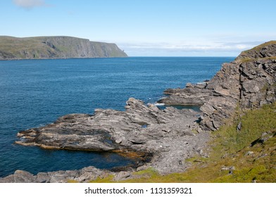 View with a layered rocks to Magerøya island in Skarsvag, Norway