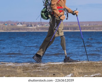 A view of the legs of a running tourist with a prosthetic leg. Active lifestyle, motivation and tourism concept. - Powered by Shutterstock